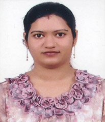 Portrait of Dr. Kapoor wearing traditional attire with academic books in background